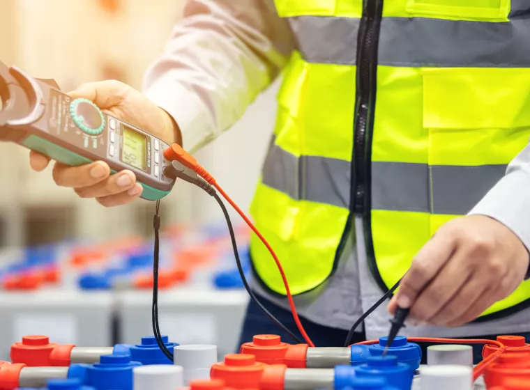 electrician using battery tester